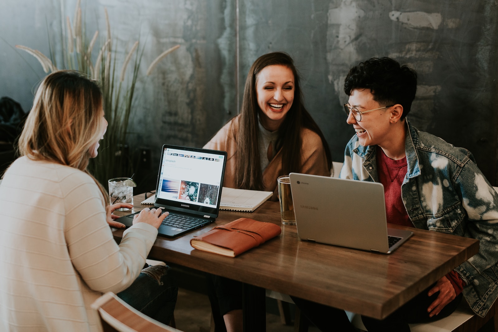 digital marketing job interviews, tips and advice, three people sitting in front of table laughing together