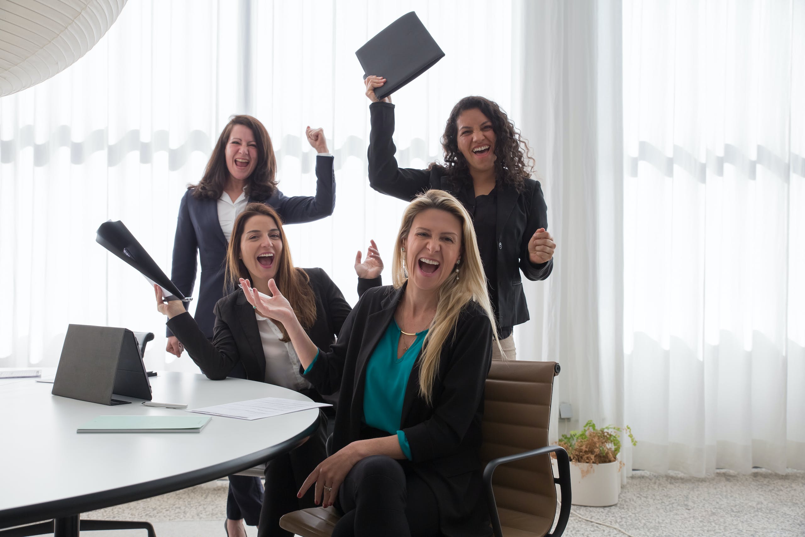 Happy Women by a Conference Room Table